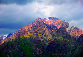 Amazing scenic view of rugged colorful mountain covered with green moss and settled by the last sun...