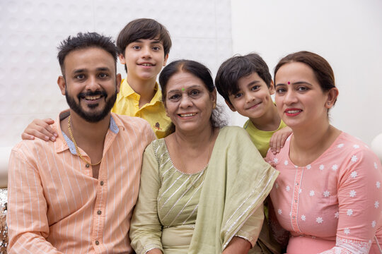 Portrait of happy family sitting together at home