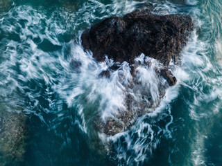 Aerial view of waves beat on the reef