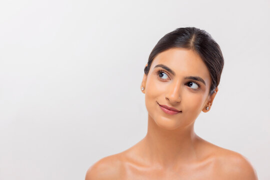 Close-up portrait of a young woman with clear and spotless skin