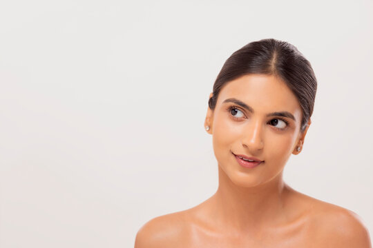 Close-up portrait of a young woman with clear and spotless skin