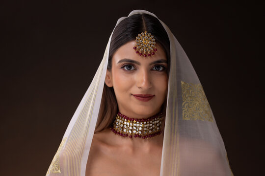 Portrait of glamorous Indian woman in ornaments and veil