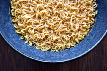 Instant noodles in a blue bowl. 