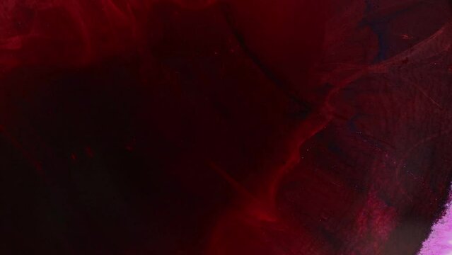 Red and pink paint creating abstract clouds. Artistic backgrounds. Fluid art drawing video, abstract texture with colorful waves.