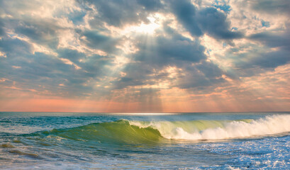 Fototapeta na wymiar Sandy coastline on Alanya beach with strong sea wave at sunset- Alanya, Antalya