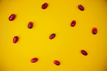 group of fresh and tender red grapes on a pastel yellow background