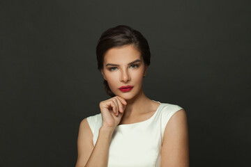 Glamourous brunette woman model with fresh makeup, red lips and dark eyebrows