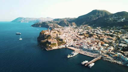 Aeolian Islands. Lipari town aerial view with drone overlooking to other islands: Hovering on Lipari city centre, Lipari's castle and Canneto's beach