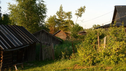 Beautiful rustic summer landscape. Old wooden log houses. Vologda region