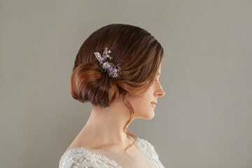 Beauty wedding hairstyle decorated with jewelry on female head, rear view