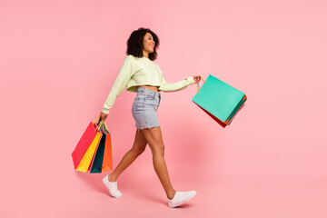 Full body profile side photo of young lady walk shop mall season discount isolated over pink color background