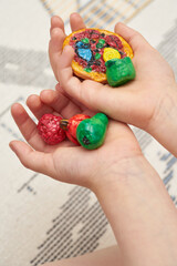 estonian children at home colored dough molding in child hands
