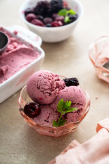 Pink ice cream scoops in glass bowl, close up. Homemade healthy sorbet with banana and berry, icecream refresing treat