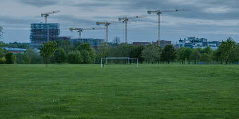 Rural soccer field in the light of the sunset, View of empty soccer goals, goals without nets, can be used as a background, background for graphic designers © Piotr