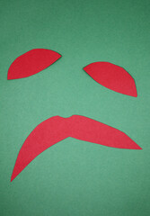 abstract red paper shapes isolated on green background