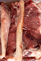 Fototapeta premium vertical close up of a tray of raw ribeye meat prepared for cooking