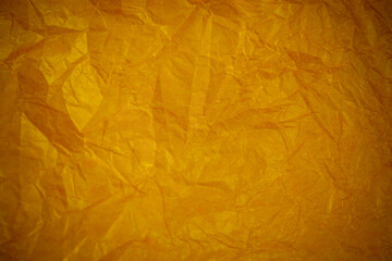 Crumpled gold paper recycling background.