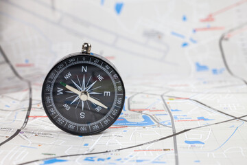 Compass on the map background of blur.