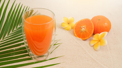 Orange Juice Into Double Wall Glass On Palm Leaf On The Beach. Refresh Summer Drink.