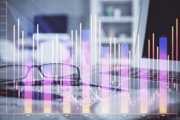 Financial chart hologram with glasses on the table background. Concept of business. Double exposure.