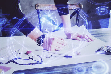 Man's hands working with notes background. Modern computer record diagram with virtual mnitor.