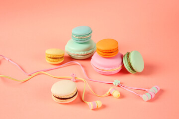 macarons and headphones on colored background