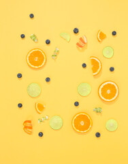 orange and lime slices on yellow background