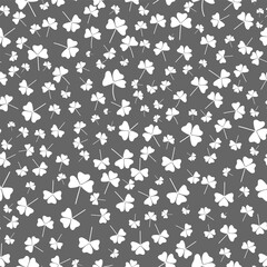 Floral seamless background. Abstract clover leaves on a gray background.