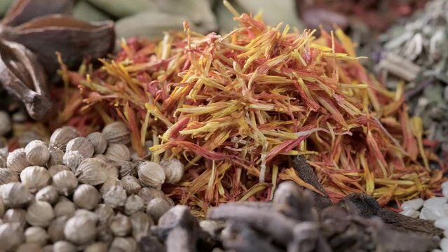 4K. Spices. Aromatic Indian spices on a slate background. Spices and herbs rotate on a stone background. Assortment of Seasonings, condiments, Dry colorful condiments. Culinary, cooking ingredients