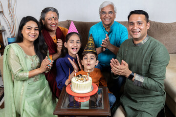 indian family celebrating birthday  at home  - Powered by Adobe