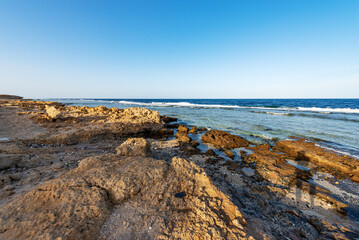 Fototapeta na wymiar Beautiful seascape of Red Sea near Marsa Alam, Egypt, Africa. The waves breaking on the coral reef and the cliff.