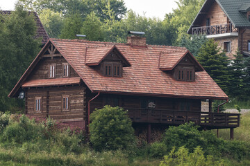 A wooden house, an old historic structure. A beautiful, intimate, wooden house in the Carpathians, Poland. Historic wooden building. A house that smells like a forest