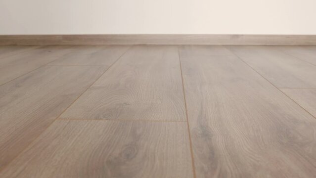 New laminate flooring. Laminated parquet with brown wooden texture