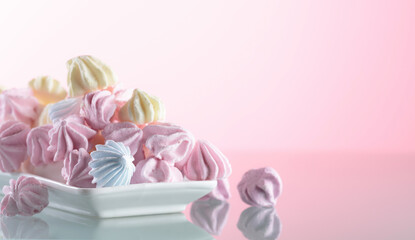 Homemade colorful meringue on a glass table.