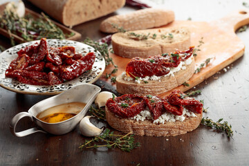 Bruschetta with ricotta, sun-dried tomatoes, and thyme.
