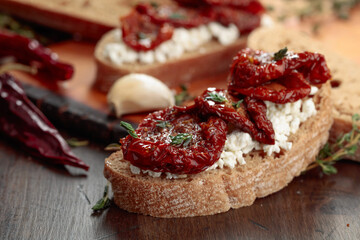 Bruschetta with ricotta, sun-dried tomatoes, and thyme.