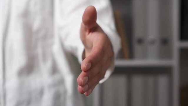 caucasian woman stretching out her hand gesture greeting, successful deal shaking hands partners shaking hands, insurance agent made a deal, holding out hand symbol of welcome

