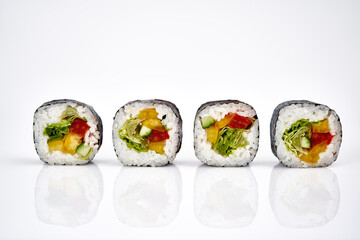 Vegetable sushi rolls isolated on a white background with shadow        