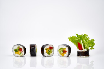 Vegetable sushi rolls isolated on a white background with shadow        