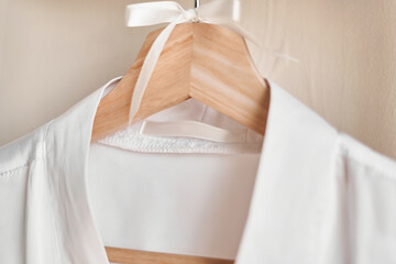 White silk robe on a wooden hanger        
