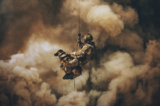 Military soldier with dog roping helicopter between mist and smoke	
