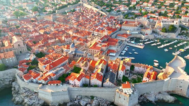 flying above Dubrovnik old town at sunset, aerial view of historic city of Dubrovnik in Croatia, UNESCO World Heritage site in Croatia, famous tourist attraction in the Mediterranean