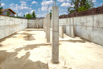 Construction site. Concrete wall foundation. Grounds for spacious building. Foundation and concrete...