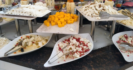 Buffet in restaurant, serving lunch or dinner for people to eat, diversity of delicious and tasty foods in a buffet, business food.