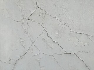 Old grey cement wall with crack and rough texture.