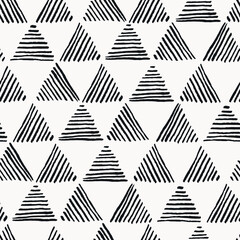 Seamless hand drawn geometric pattern with black striped triangles