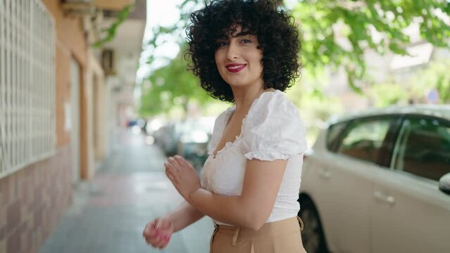 Young middle east woman smiling confident standing with arms crossed gesture at street