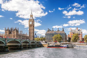 Famous Big Ben with bridge over Thames and tourboat on the river in London, England, UK - 509994953