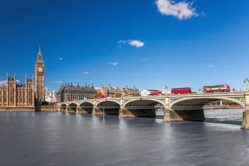Foto auf Acrylglas Famous Big Ben with red buses on bridge over Thames river in London, England, UK © Tomas Marek
