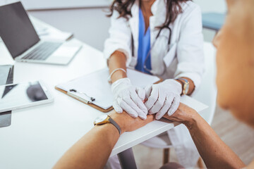 Doctor and patient are discussing something in clinic, just hands at the desk. Medicine and best service concept. Doctor reassuring patient woman while sitting at the desk in clinic